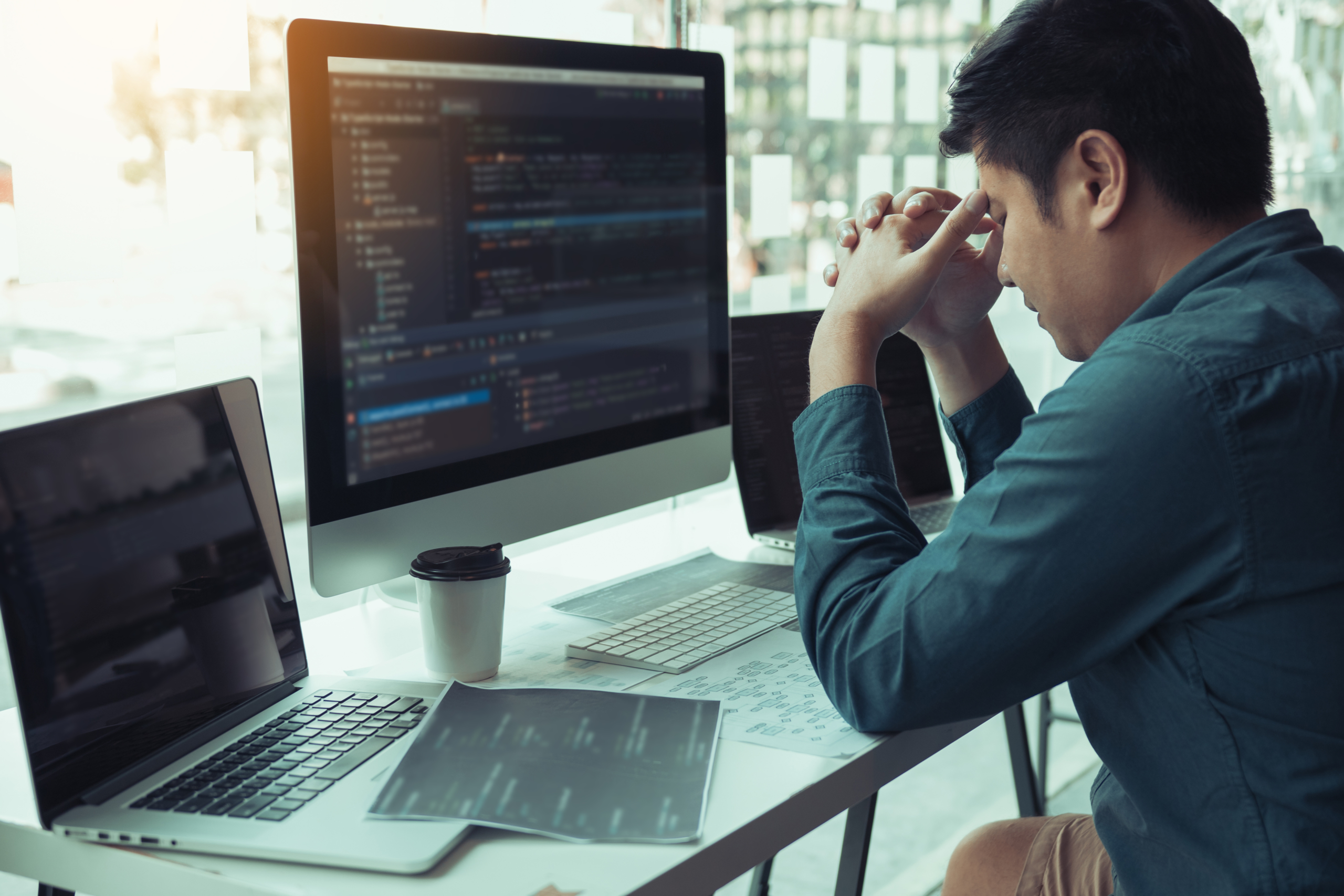 Software,Developers,Headache,With,Code,Analysis,In,The,Office. lawyer at desk