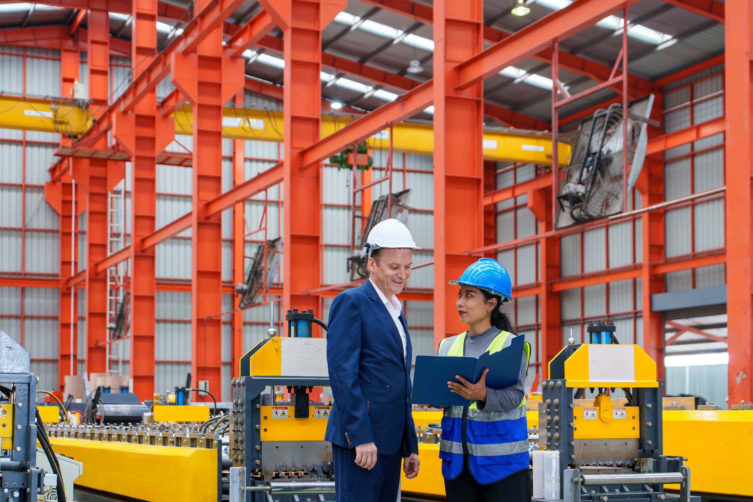 Quality and compliance manager reviewing audit documentation in a manufacturing facility
